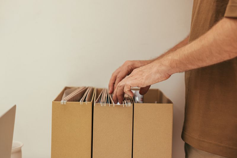 Person organizing documents in a filing system