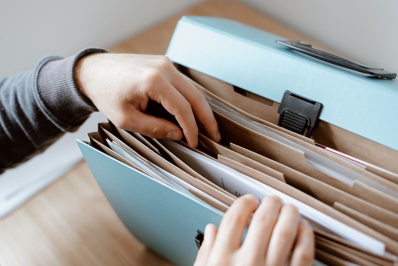 Person selecting a document from an organized folder